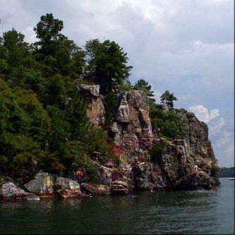 This is Chimney Rock, located on an island of the same name, near the center of the lake area.  It is the scene in the summer of many daredevil young folks jumping into the lake from various levels on the rock formation.