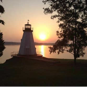 This is a sunrise view of Children's Harbor lighthouse, located in the Kowaliga area of the lake.  It is part of a complex of buildings called Children's Harbor, a facility dedicated to providing some recreational time for children dealing with long term or terminal diseases.