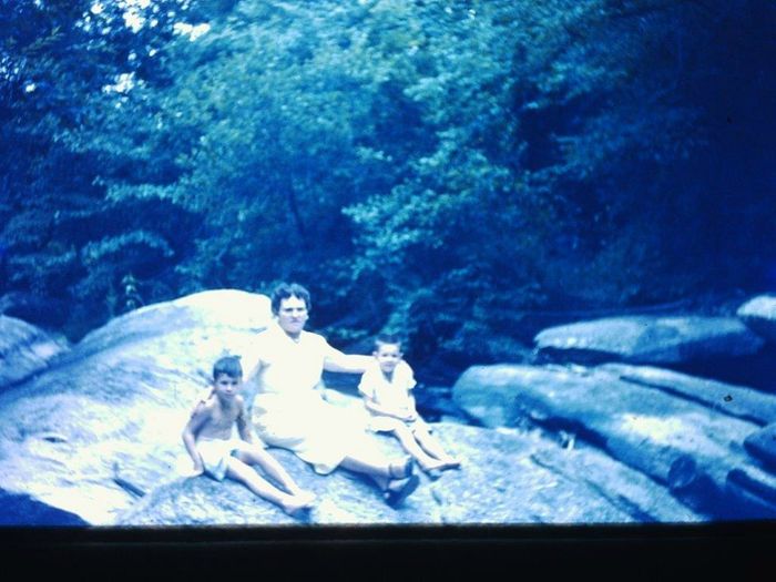 Ms. Mary Alma Taylor Hall Moore, daughter of Mr. Ivora Taylor, enjoying a sunny day moment with two of her grandsons, Mark and Matt Hall.  They are shown on the rocks near the mill race of her grandfathers grist mill on Gold Branch Creek, just behind the home where she grew up, just off East Cotton Road.  Ms. Moore was born on January 16, 1905 and died on December 22, 1986 at almost 81 years of age. 