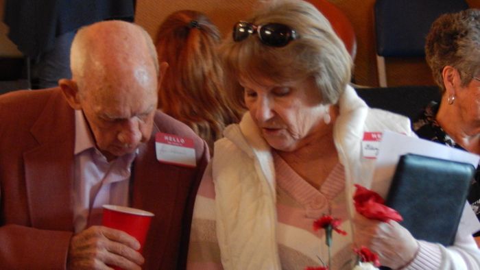 Joe Atkisson and Gloria Nail Graham enjoying some items on the Mementos from the Past table.
